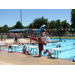 A lifeguard standing watch over children at the pool on a sunny day. 