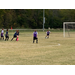 Youth soccer goalie stopping the ball.