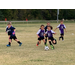 Youth soccer player breaking away and taking the ball down the field.