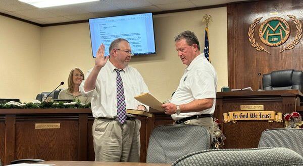 Scott Liles being sworn in by Mayor Adams