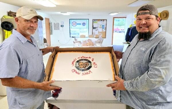 PW employees with large cake