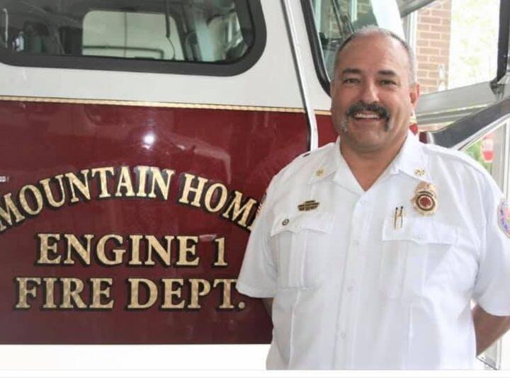 Fire Chief Kris Quick in front of fire engine