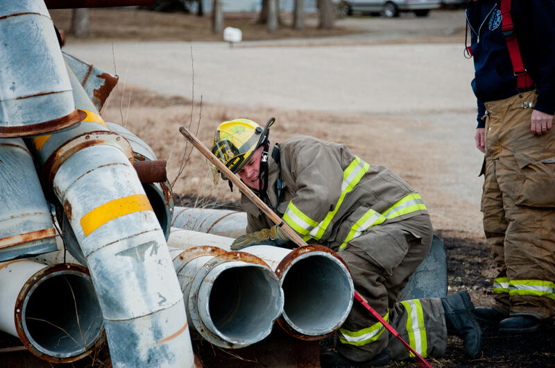 Fireman moving piping