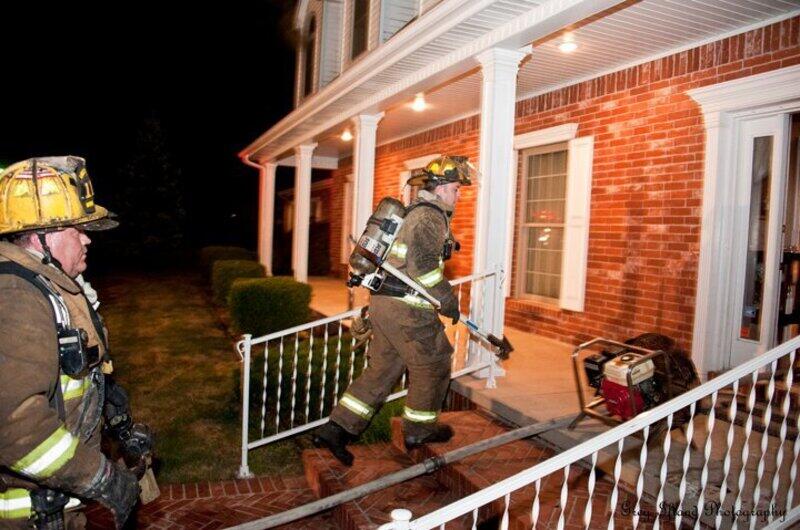 Two firemen going into a house