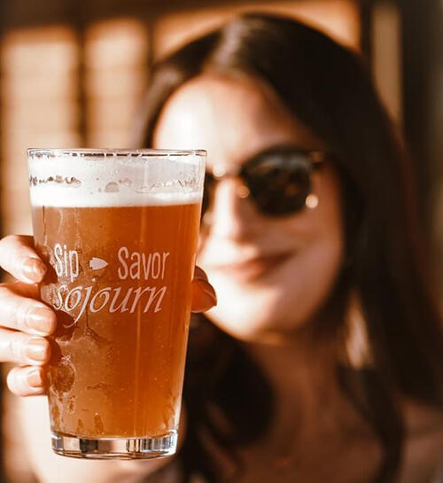 woman holding glass of beer