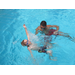 A young boy working on swimming skills with his male instructor. 