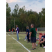 Coaches on the sideline intently watching the game.