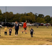 Youth soccer coach instructing team.