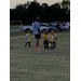Youth soccer players getting instruction from their coach.
