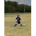 Youth soccer player kicking the ball.