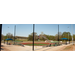 Baseball field with fire truck and flag in background.